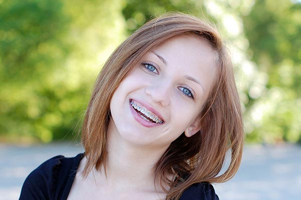 A young woman with short brown hair and blue eyes smiling at the camera.
